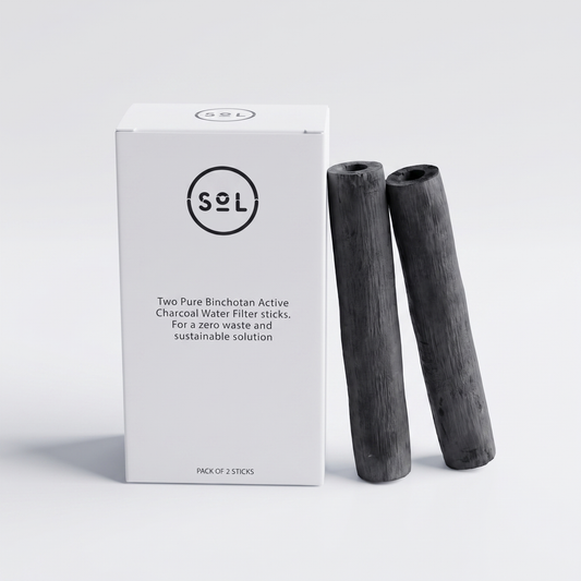 SoL Pure Binchotan Active Charcoal Water Filter Sticks box with the two hollow charcoal tube sticks standing beside it, white studio
